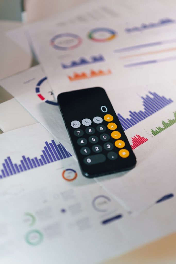 Calculator on graphs showing financial data and analytics. Ideal for business and finance themes.